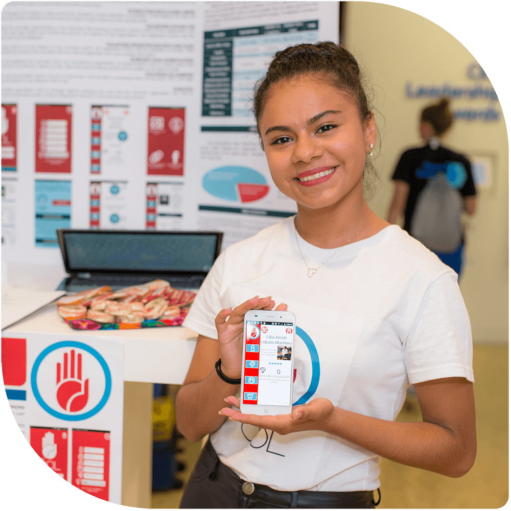 A Technovation student showing the app her team built